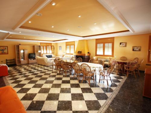 a room with a checkered floor with tables and chairs at Private villa en baza in Baza