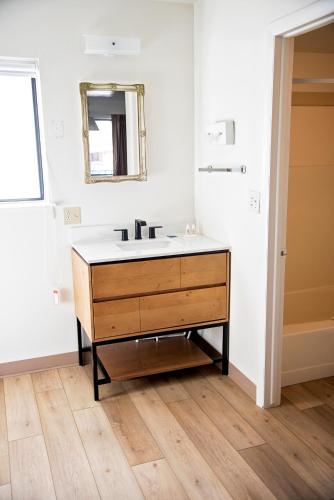 a bathroom with a sink and a mirror at The Virginian Inn Moab Downtown in Moab