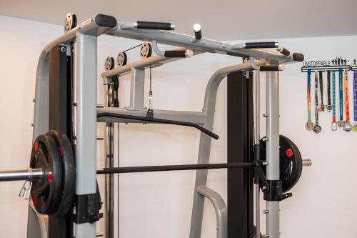 a gym rack with a barbell and weights at Dayin Youth Hostel - East Nanjing Road & People's Square & The Bund -Large Social Area -Bar -Café -Gym -Free Laundry Luggage Storage -24H Front Desk -English Service in Shanghai