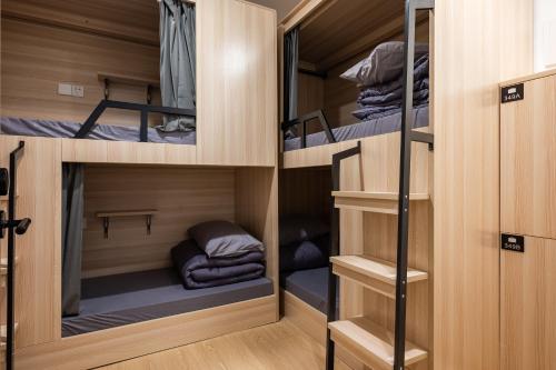a room with four bunk beds in a room at Dayin Youth Hostel - East Nanjing Road & People's Square & The Bund -Large Social Area -Bar -Café -Gym -Free Laundry Luggage Storage -24H Front Desk -English Service in Shanghai