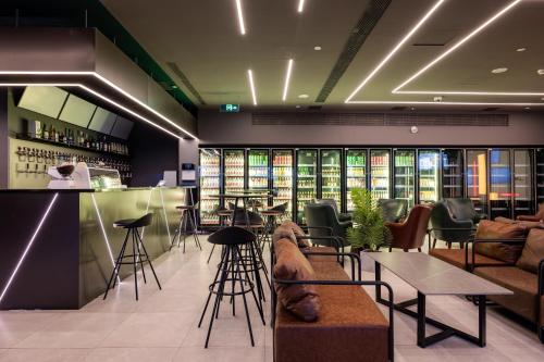 a bar with chairs and tables in a restaurant at Dayin International Youth Hostel East Nanjing Road & The Bund in Shanghai