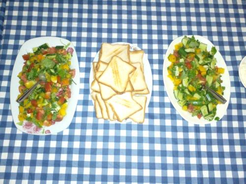 three plates of food on a blue and white table at Lake Lane Guest Rest in Koggala