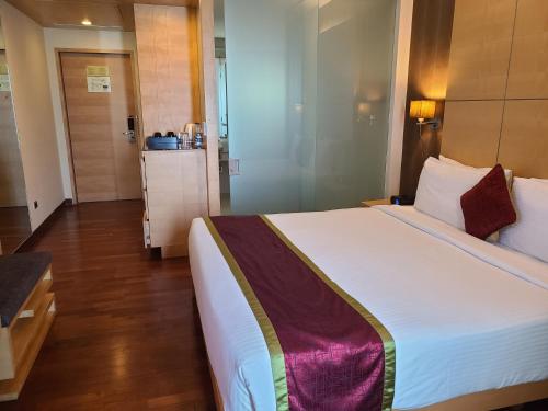 a bedroom with a large bed in a room at Novotel Hyderabad Airport in Hyderabad