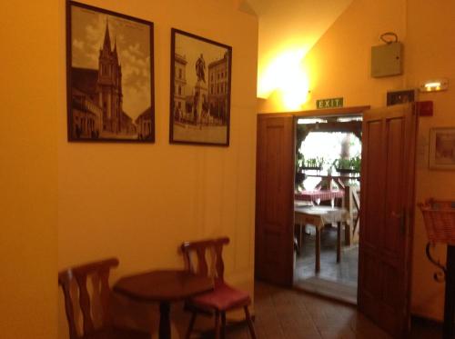 a room with a table and chairs and a dining room at Penzión Duna & soľná jaskyňa in Komárno