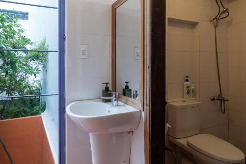a bathroom with a sink and a toilet at The Bohome in Quy Nhon