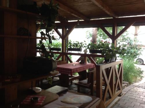 a wooden porch with a table and a table sidx sidx sidx at Penzión Duna & soľná jaskyňa in Komárno