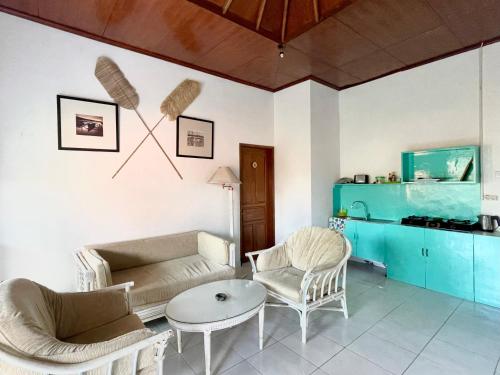 a living room with a couch and chairs and a table at NIKINIKO Beach House by Lolavillas - 100mts to the beach in Canggu