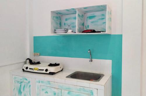a kitchen with a sink and a toaster at NIKINIKO Beach House by Lolavillas - 100mts to the beach in Canggu