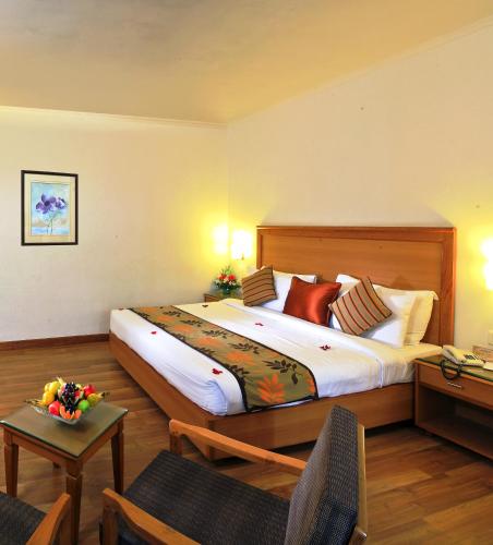 a bedroom with a large bed in a room at Hotel Abad Plaza in Cochin