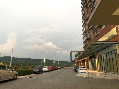 a street with cars parked in a parking lot at DanZaStay@BellSuite in Sepang
