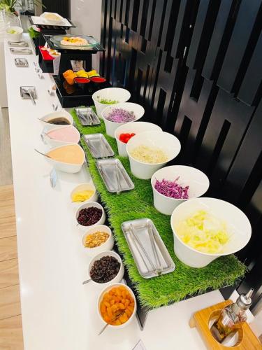 a buffet line with bowls of different types of food at Sonnien Hotel in Taipei
