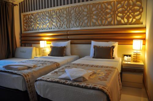 Säng eller sängar i ett rum på Elamir Resort Hotel