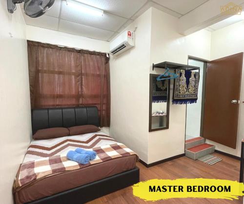 a bedroom with a bed in a room at Adina Homestay Langkawi ~Spacious Homestay~ in Kuah