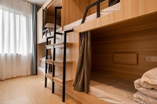 a bedroom with bunk beds in a room at Dayin Youth Hostel - East Nanjing Road & People's Square & The Bund -Large Social Area -Bar -Café -Gym -Free Laundry Luggage Storage -24H Front Desk -English Service in Shanghai