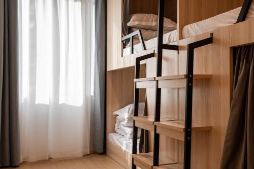 a room with two bunk beds with a window at Dayin Youth Hostel - East Nanjing Road & People's Square & The Bund -Large Social Area -Bar -Café -Gym -Free Laundry Luggage Storage -24H Front Desk -English Service in Shanghai