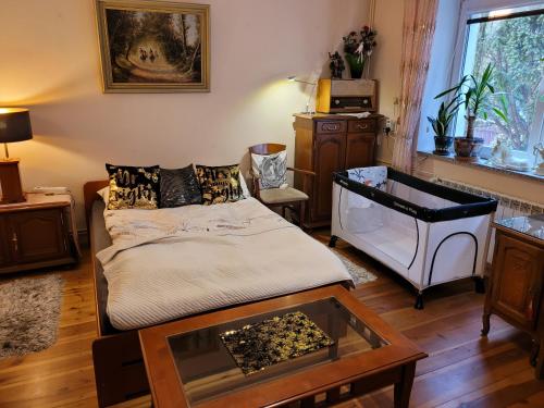 a living room with a bed and a table at ApartHome Barbara 2 in Toruń