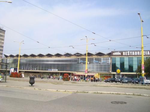 a building on a street in front of a city at Hotel Štadión in Košice