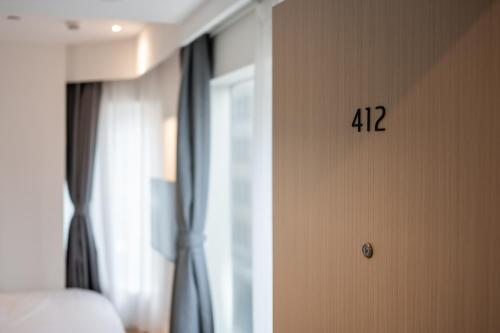 a room with a wall with a clock on it at Dayin Youth Hostel - East Nanjing Road & People's Square & The Bund -Large Social Area -Bar -Café -Gym -Free Laundry Luggage Storage -24H Front Desk -English Service in Shanghai
