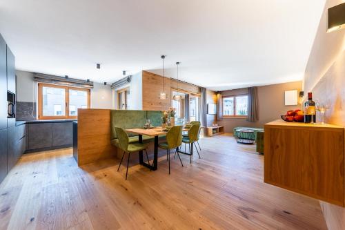 a kitchen and dining room with a table and chairs at Rienz Alpine City Lofts in Brunico