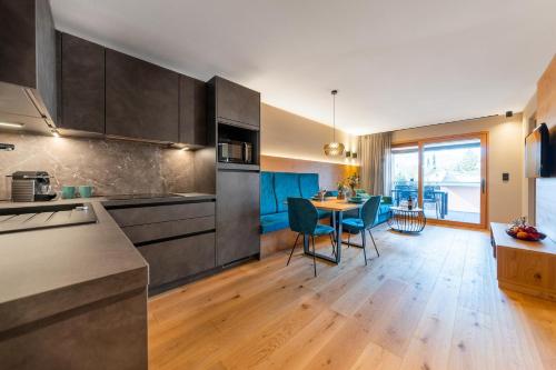 a kitchen with a table and a dining room at Rienz Alpine City Lofts in Brunico