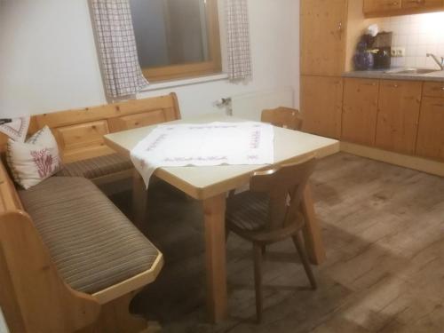 a kitchen with a table and chairs and a table and a table at Appartement-Pension Familie Gewessler in Bad Mitterndorf