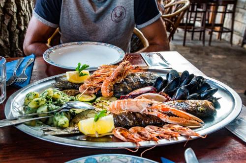 a plate of food with seafood on a table at Modern Oceanview in Metajna