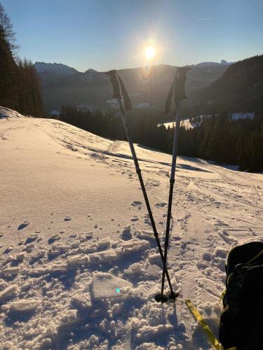 a pair of ski poles standing in the snow at Appartement-Pension Familie Gewessler in Bad Mitterndorf