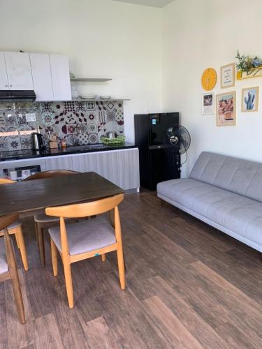 a living room with a table and a couch at Alina Retreat in Hiếu Nhơn