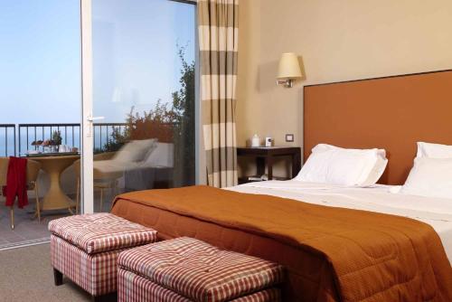 a hotel room with a bed and a balcony at Villa Maria Hotel & SPA in Francavilla al Mare