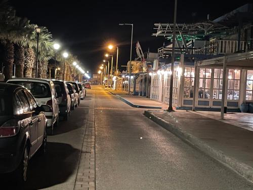 a street at night with cars parked on the street at Lefteris Apartment in Kardamaina
