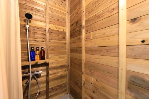 a sauna with wooden walls and bottles of wine at リバウッドリゾート in Mori