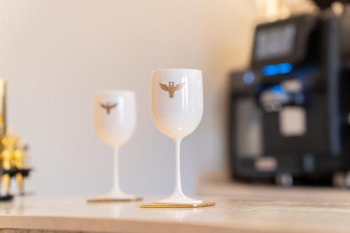 two wine glasses sitting on top of a counter at Relais Forte Benedek Wine & SPA - Adults Only in Pastrengo