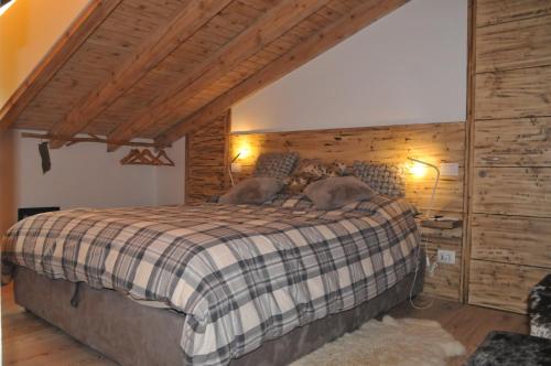 a bedroom with a bed with two dogs laying on it at Mansarda la Baita in Madonna di Campiglio