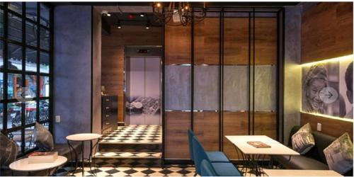 a restaurant with a lobby with tables and chairs at Gemini Saigon LUXURY in Ho Chi Minh City