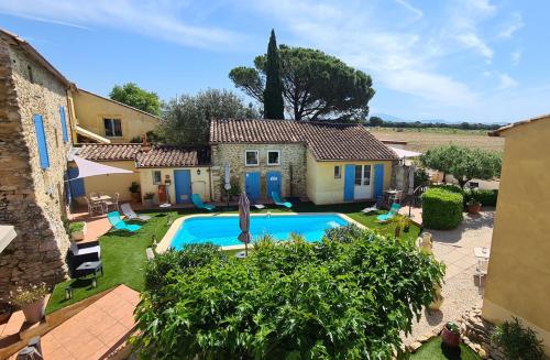 an external view of a villa with a swimming pool at Logis Hôtel La Bastide Saint Bach in Suze-la-Rousse