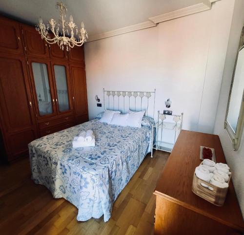 a bedroom with a bed with two towels on it at Chiqui Home in Salamanca