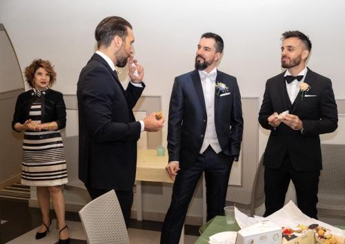 a group of three men in suits standing next to a woman at B&B San Trifone in Adelfia