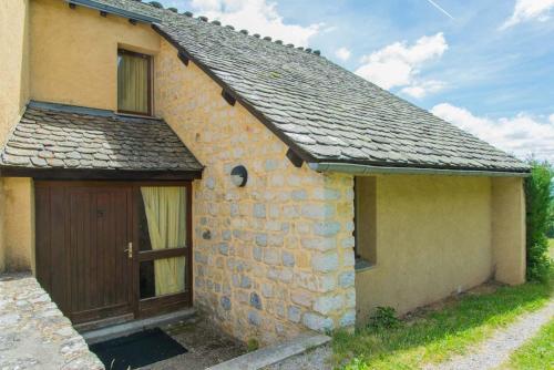 a small stone house with a wooden door at Village de gîtes de Sainte-Lucie in Sainte-Lucie
