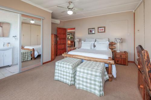 a bedroom with a large bed and a sink at 18 On Kloof Guest House in Gordonʼs Bay