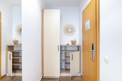 a door leading into a room with a closet at TCI Apartments in Cluj-Napoca