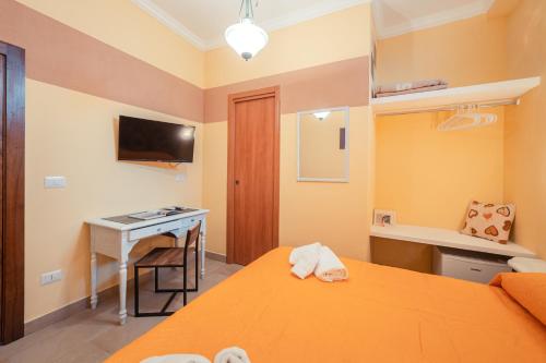 a room with a desk and a bed and a desk at Taormina Garden Hotel in Taormina