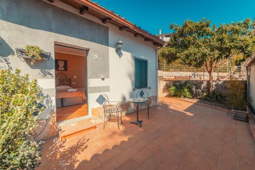 a patio with a table and a bed in a house at Taormina Garden Hotel in Taormina