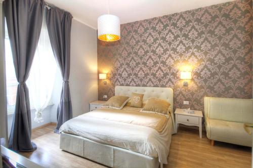 a bedroom with a bed in a room with a wall at Sweet Home Faleria in Rome