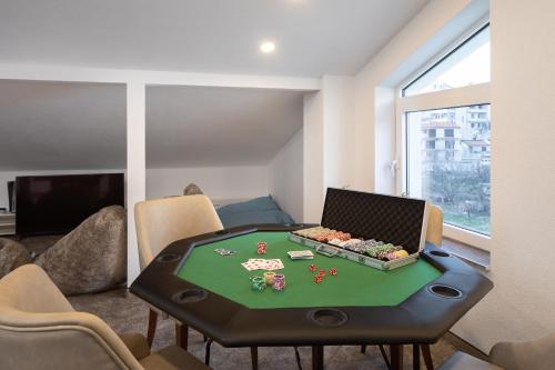 a room with a poker table in a room with chairs at Elais Luxury Residence in Podstrana