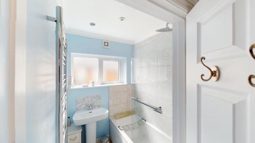 a bathroom with a white toilet and a sink at Smyrna Cottage in Sidmouth