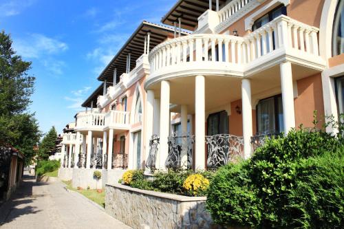 a large white house with balconies on a street at Villas Elenite Premium in Elenite