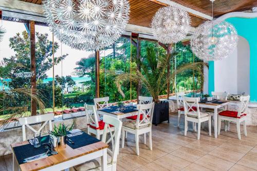 a restaurant with tables and chairs and large windows at Villas Elenite Premium in Elenite