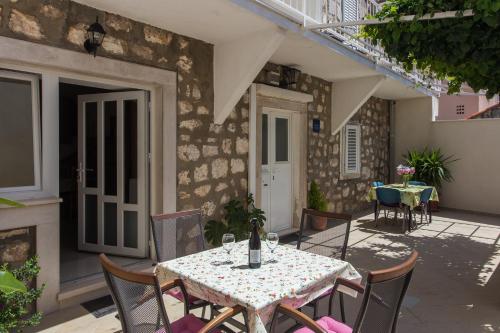 
a patio table with chairs and a table cloth at Apartments Aurelia in Dubrovnik
