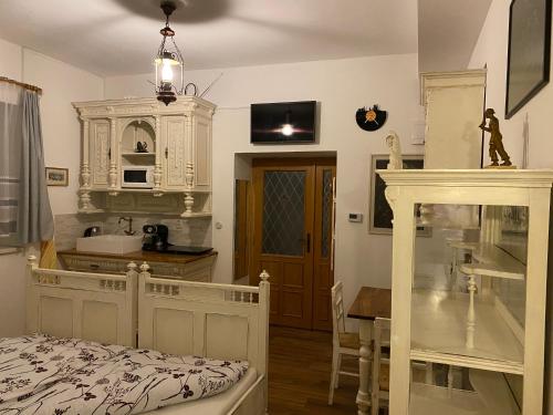 a bedroom with a bed and a kitchen with a table at Penzio Ostrava in Ostrava