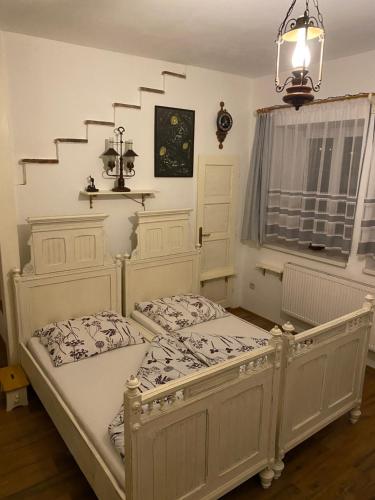 a bedroom with two beds and a chandelier at Penzio Ostrava in Ostrava